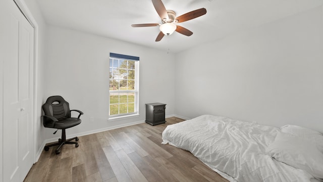 bedroom with light hardwood / wood-style flooring, a closet, and ceiling fan