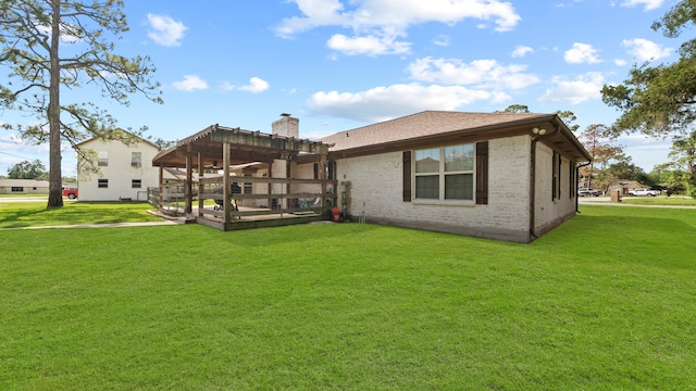 rear view of property with a pergola and a yard