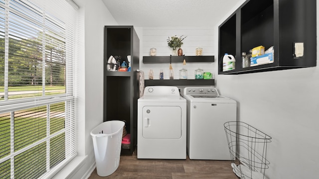 laundry area featuring a healthy amount of sunlight, a textured ceiling, dark hardwood / wood-style flooring, and separate washer and dryer