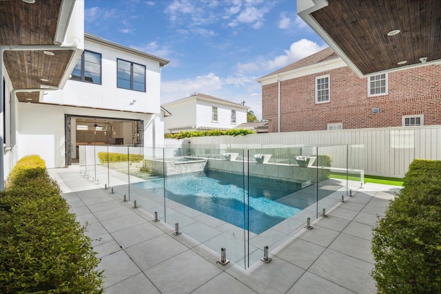 view of pool with an in ground hot tub and a patio