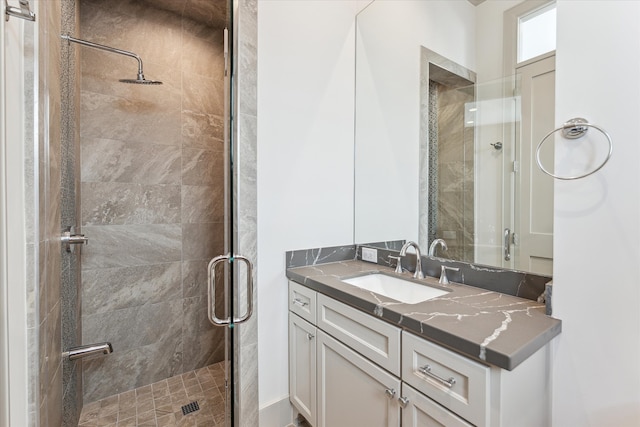 bathroom featuring an enclosed shower and vanity