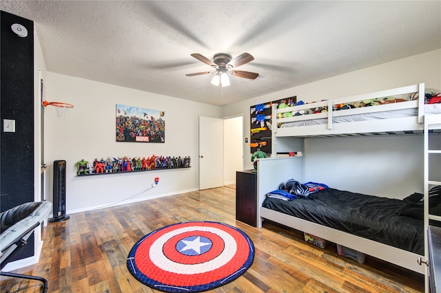 bedroom with hardwood / wood-style floors, a textured ceiling, and ceiling fan