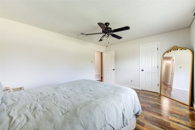 bedroom with dark wood-type flooring and ceiling fan