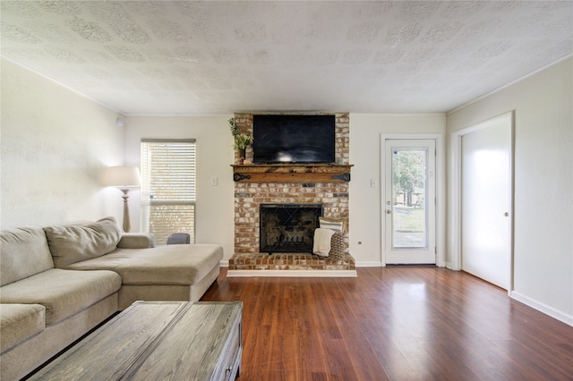 living room featuring a fireplace, a textured ceiling, and dark hardwood / wood-style floors