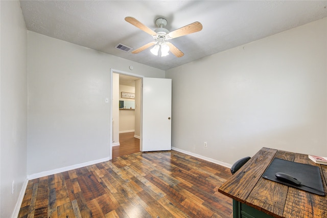 unfurnished office featuring dark wood-type flooring, ceiling fan, and a textured ceiling