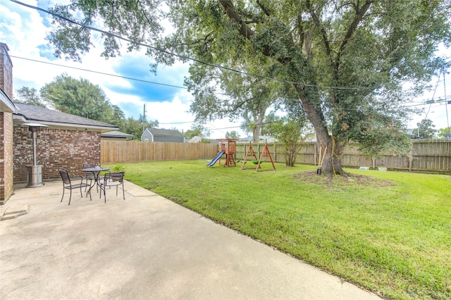 view of yard featuring a patio and a playground