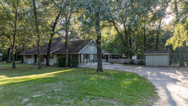 ranch-style house featuring a shed and a front yard