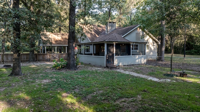 view of front of property featuring a sunroom and a front yard