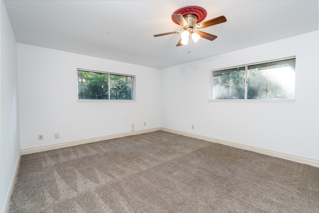 carpeted empty room featuring ceiling fan and plenty of natural light