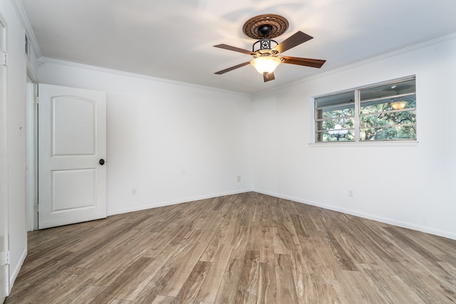 spare room with ceiling fan, ornamental molding, and hardwood / wood-style floors