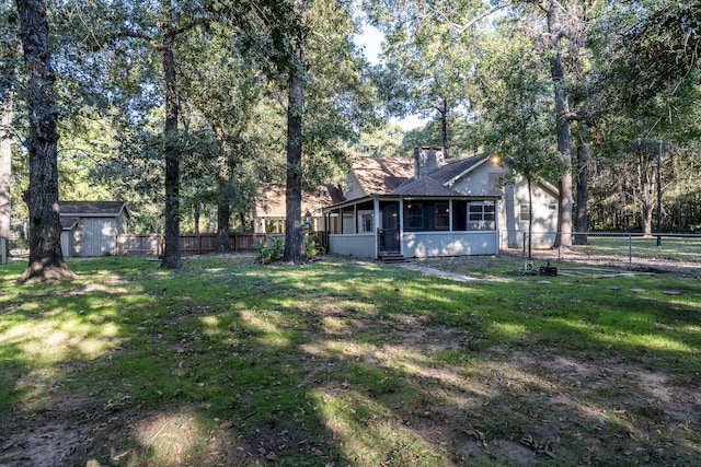 view of yard featuring a shed and a sunroom