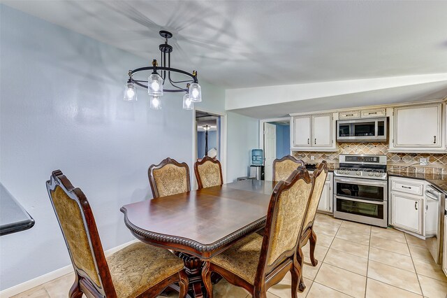 dining room featuring an inviting chandelier and light tile patterned flooring