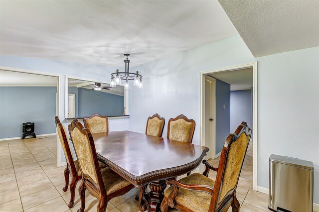 dining room featuring a textured ceiling, ceiling fan with notable chandelier, and light tile patterned floors