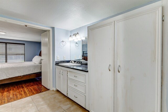 bathroom featuring a textured ceiling, vanity, and hardwood / wood-style floors