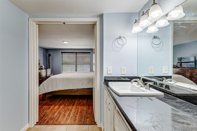 bathroom featuring tile patterned flooring and vanity