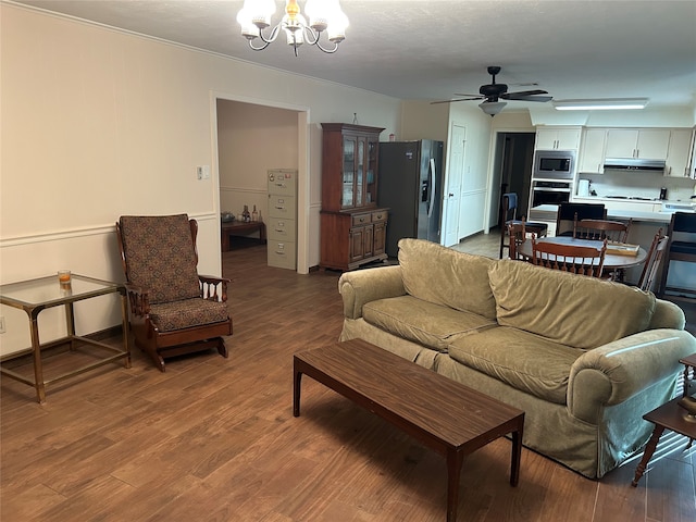 living room featuring ceiling fan with notable chandelier and hardwood / wood-style flooring