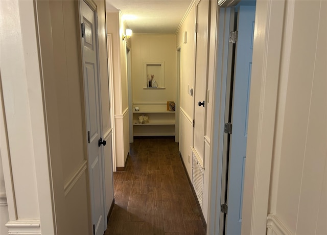 hall featuring dark wood-type flooring and crown molding