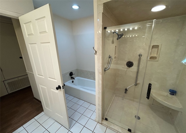 bathroom with hardwood / wood-style floors and plus walk in shower