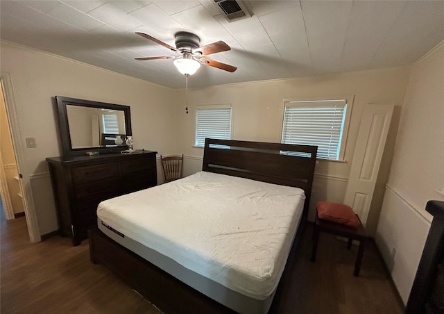 bedroom with ceiling fan, hardwood / wood-style flooring, and ornamental molding