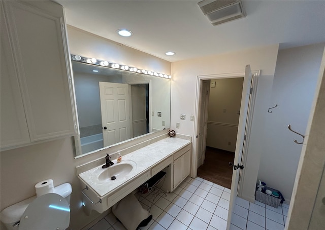 bathroom featuring tile patterned floors, vanity, and toilet