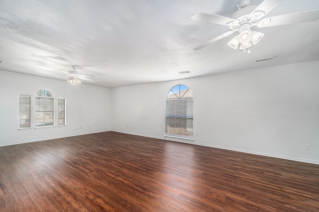 spare room with ceiling fan, dark hardwood / wood-style flooring, and a textured ceiling