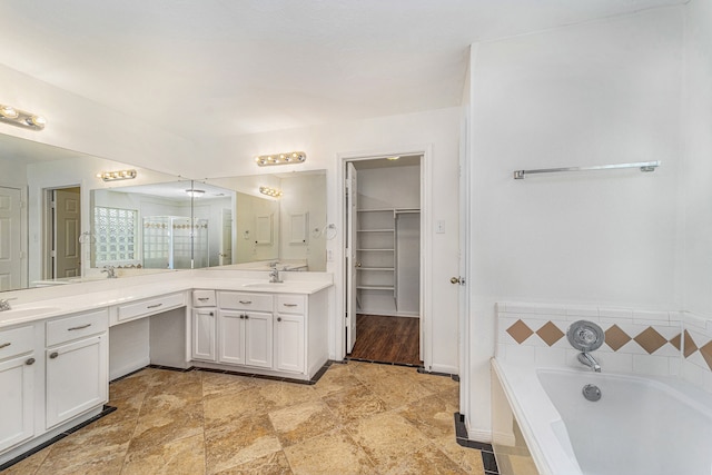 bathroom with vanity and a tub to relax in