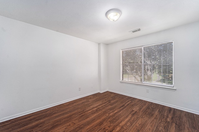 spare room with dark hardwood / wood-style floors