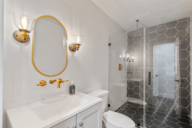 bathroom featuring walk in shower, vanity, tile walls, and toilet