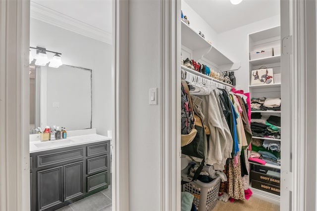 walk in closet featuring light tile patterned floors and sink