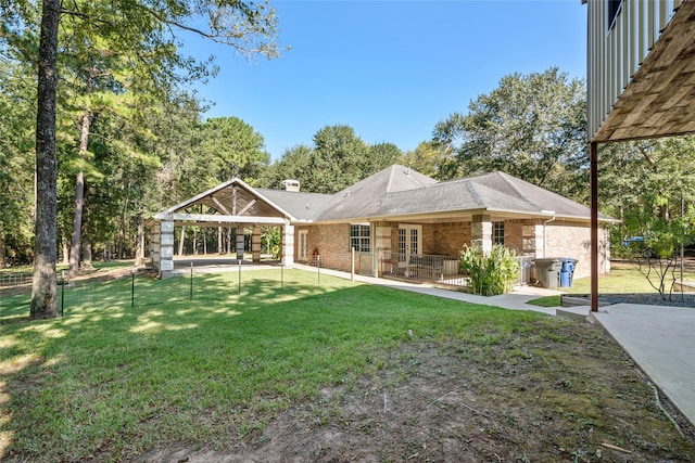 rear view of house featuring a patio and a yard