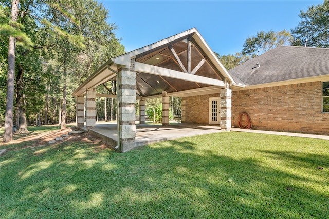 rear view of house featuring a patio and a yard