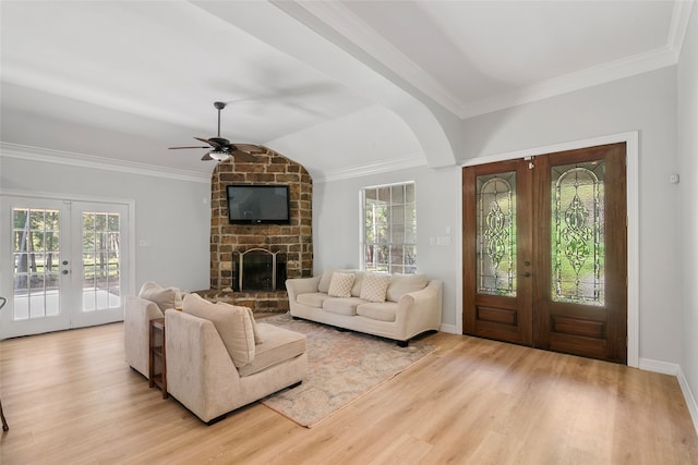 living room featuring light hardwood / wood-style flooring, french doors, and plenty of natural light