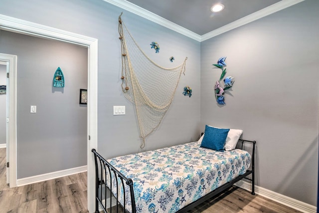 bedroom featuring ornamental molding and hardwood / wood-style flooring