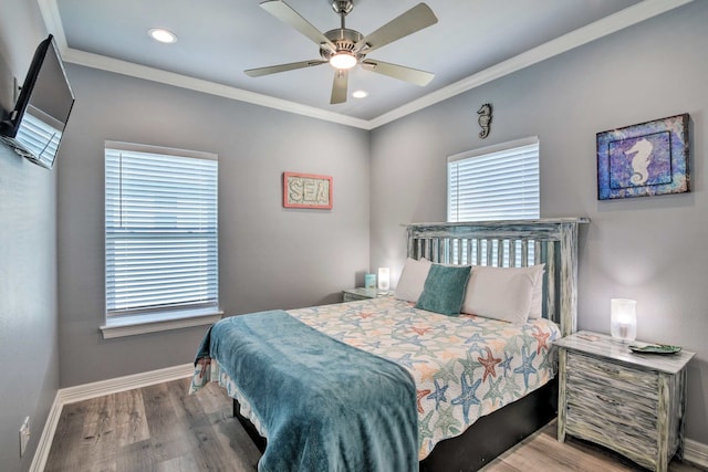 bedroom featuring light hardwood / wood-style floors, multiple windows, ornamental molding, and ceiling fan