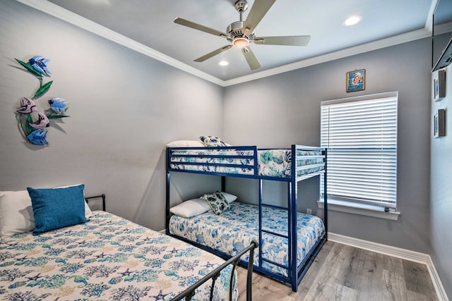 bedroom featuring ornamental molding, hardwood / wood-style flooring, and ceiling fan