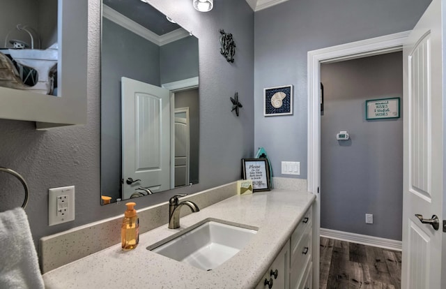 bathroom featuring vanity, ornamental molding, and hardwood / wood-style flooring