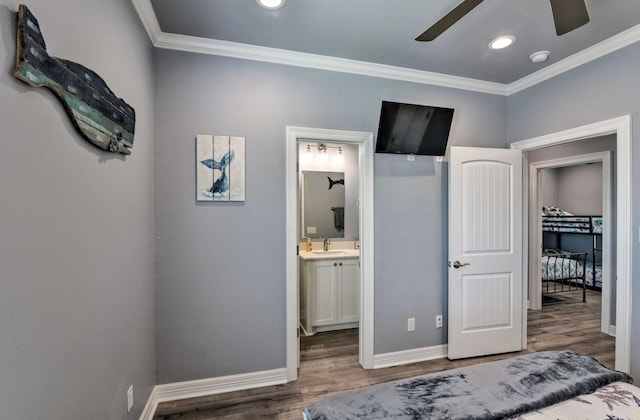 bedroom featuring sink, crown molding, wood-type flooring, and ceiling fan