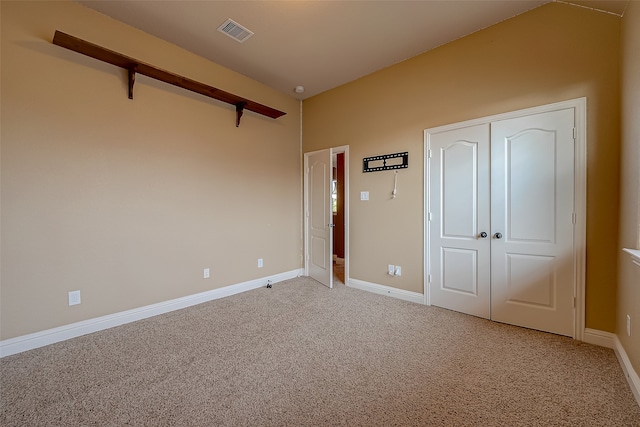 unfurnished bedroom featuring carpet flooring and a closet