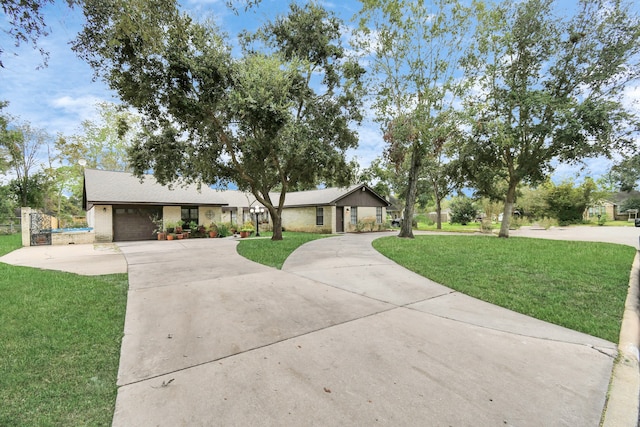 ranch-style home with a front lawn and a garage