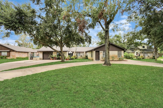 73 Surrey Oak Ct, Alvin, TX 77511 - mid-century inspired home with brick siding, driveway, and a front lawn
