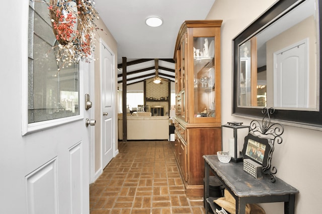 doorway featuring a fireplace and vaulted ceiling