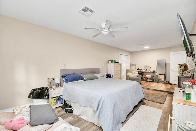 73 Surrey Oak Ct, Alvin, TX 77511 - bedroom featuring light wood finished floors and ceiling fan
