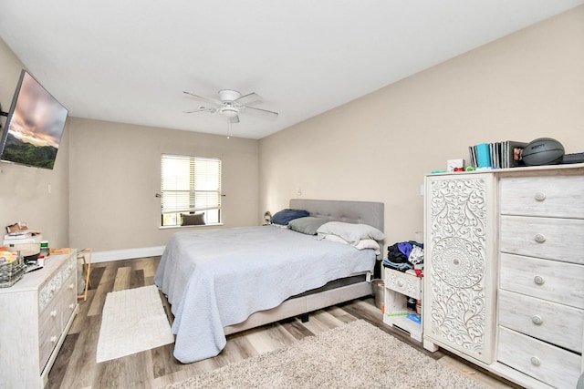 73 Surrey Oak Ct, Alvin, TX 77511 - bedroom with wood finished floors, ceiling fan, and baseboards