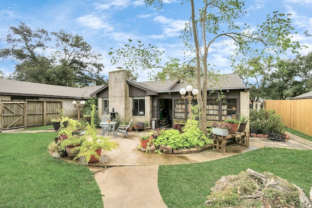 rear view of house with a yard and a patio