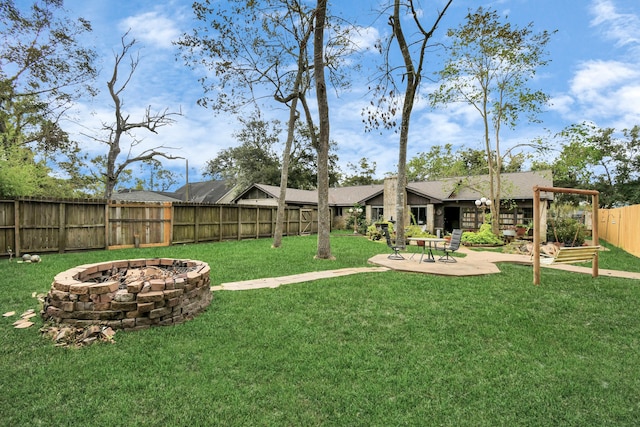 view of yard with an outdoor fire pit and a patio area