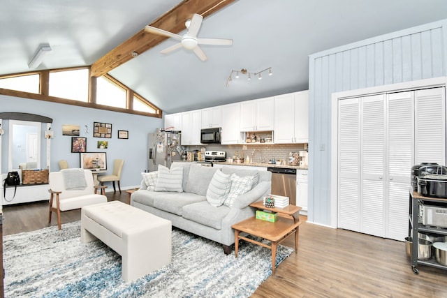 living room with ceiling fan, light wood-type flooring, beam ceiling, and high vaulted ceiling