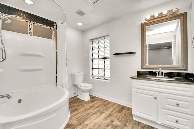 full bathroom featuring wood-type flooring, vanity, toilet, and shower / bathtub combination