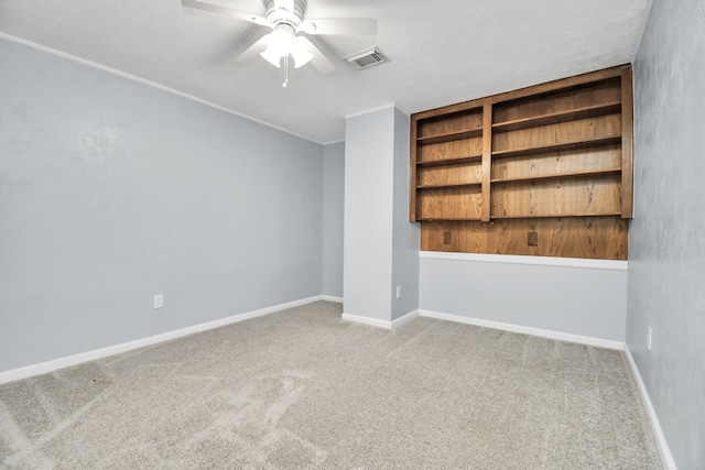 carpeted empty room featuring ceiling fan