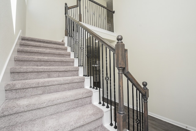 stairs featuring wood-type flooring