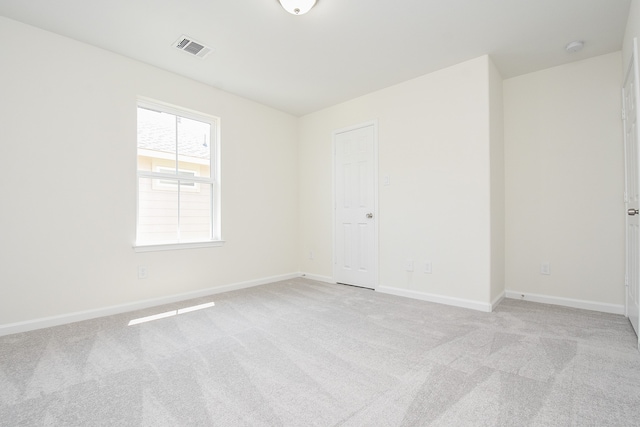 unfurnished room featuring light carpet